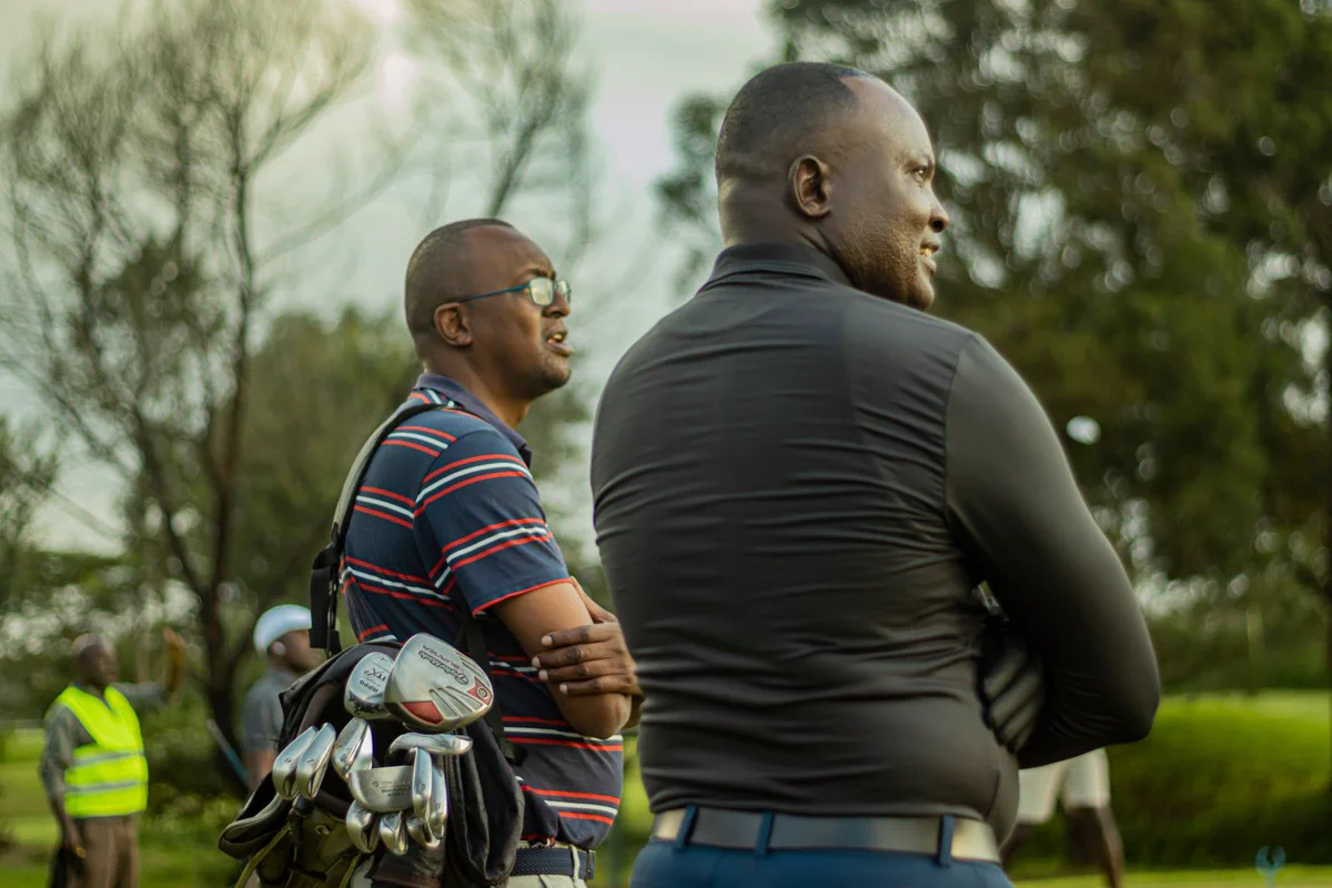 Golfers and event staff on the course during a tournament