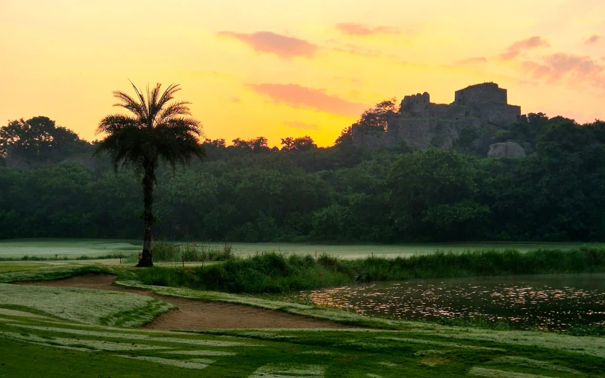Golden sky over the golf course and fort at Hyderabad Golf Association.