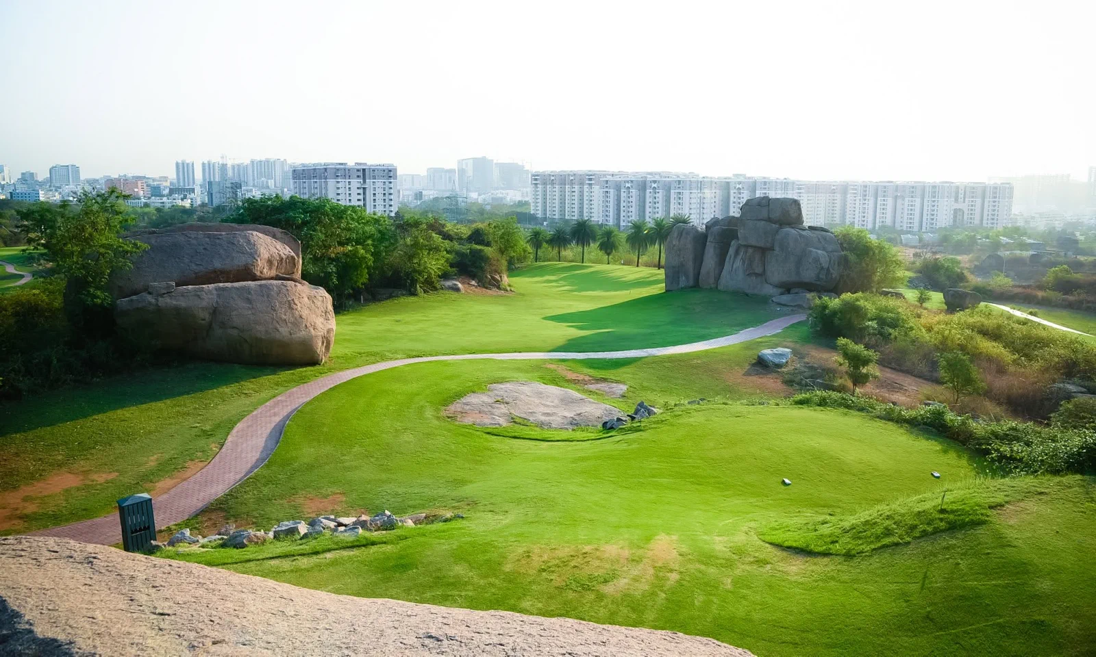 Golfers walking the course at sunset
